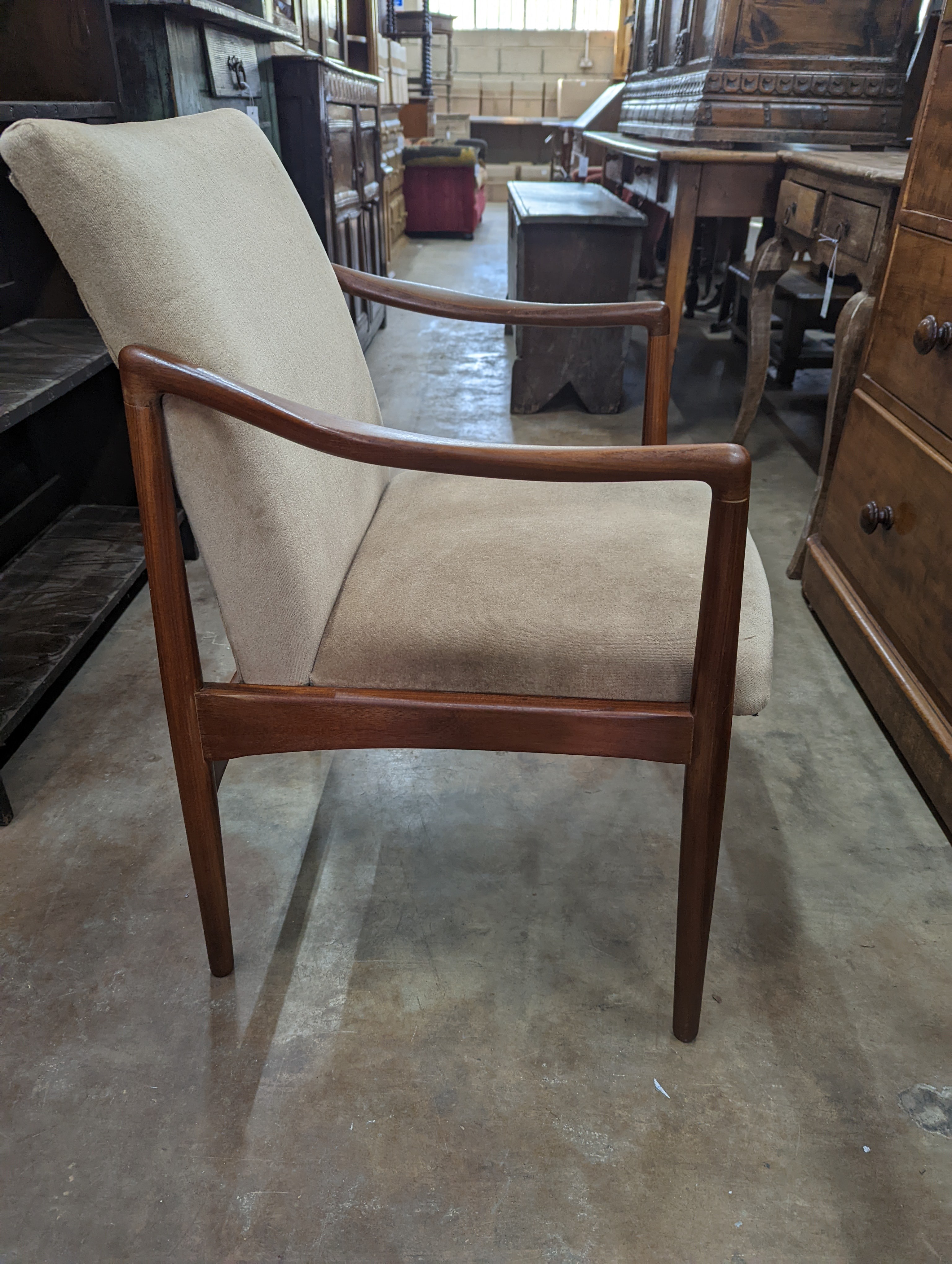 A pair of mid century teak upholstered elbow chairs, width 54cm, depth 63cm, height 84cm